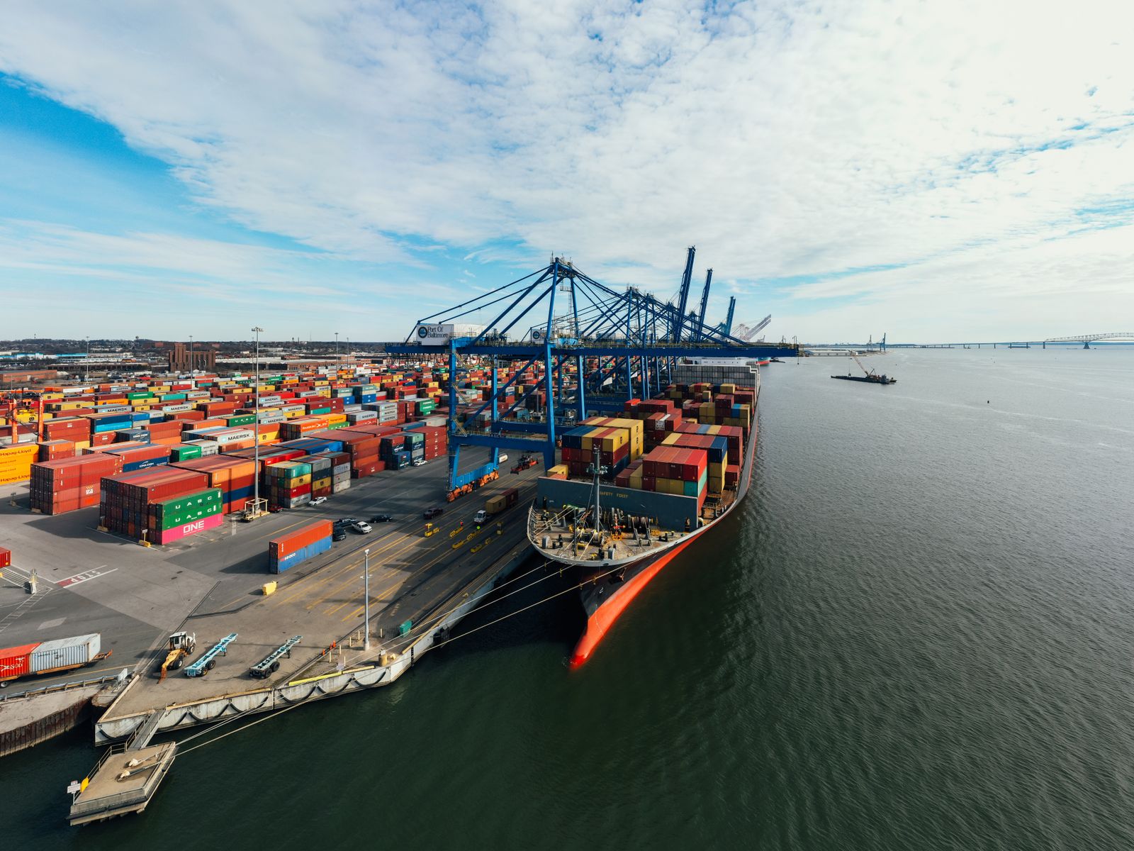 Container ship and port cranes at a freight terminal